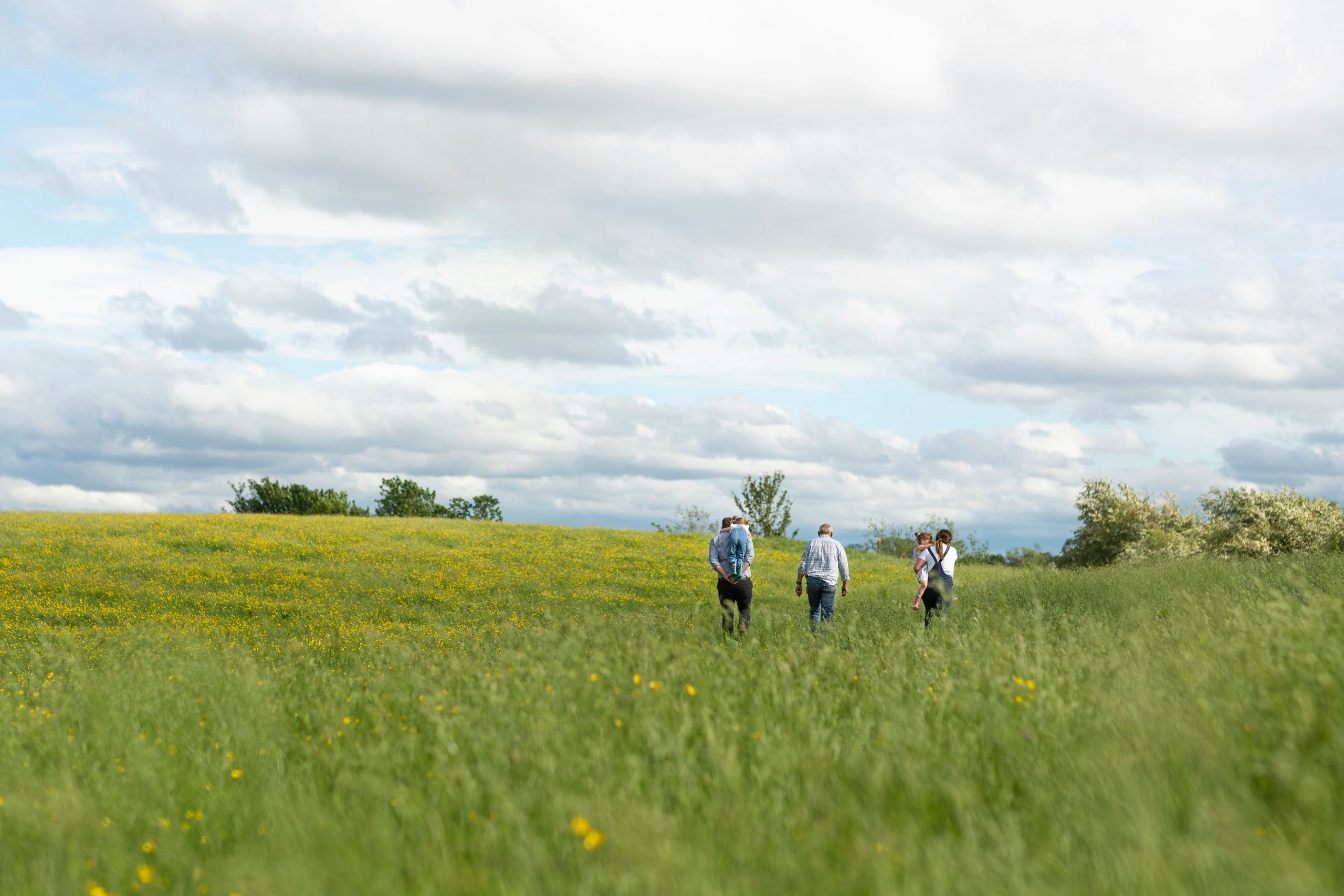 Field researchers walking outdoors during biodiversity survey work
