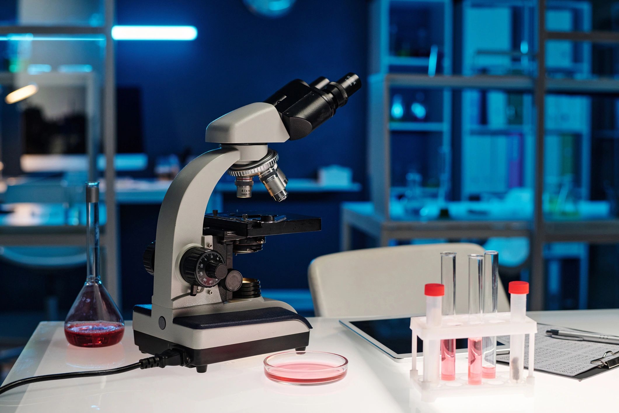 Scientific laboratory desk with microscope and research equipment
