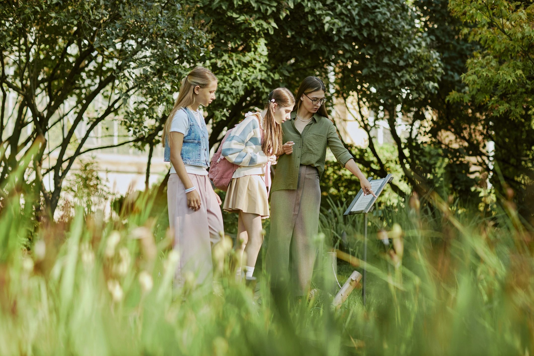 Students learning about plants in a botanical garden setting