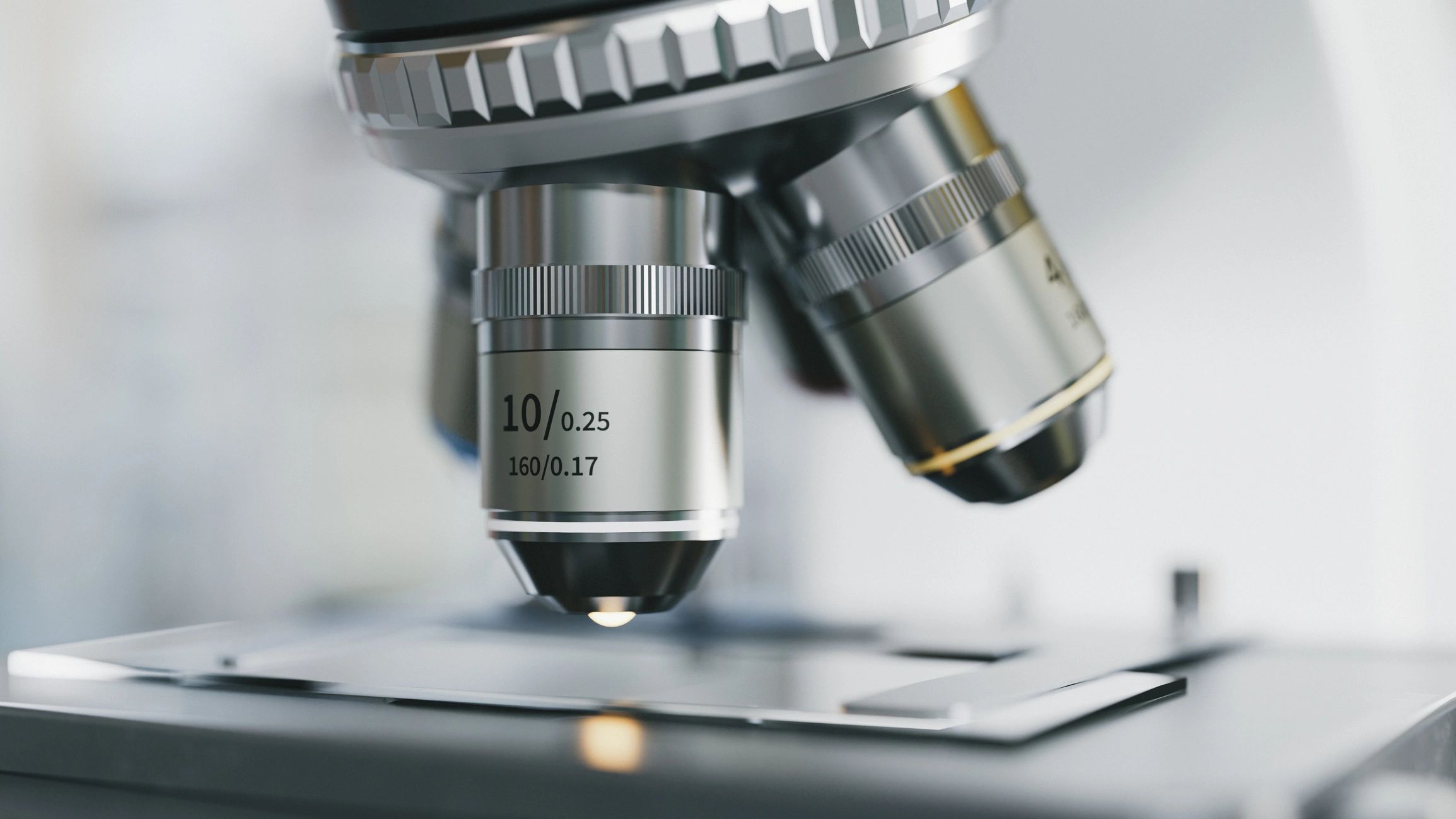 Microscope objective lens positioned over a research slide